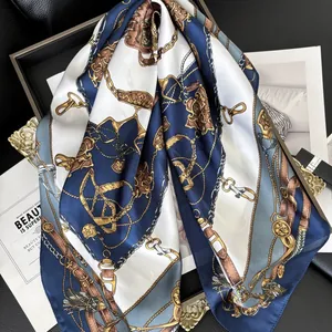 Navy blue silk scarf with equestrian horse bit and chain patterns on black leather background