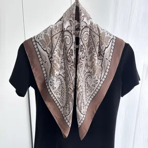 Detail of vintage paisley silk square scarf paired with a black t-shirt for women