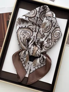 Detail of vintage paisley silk square scarf in a premium gift box with brown patterns