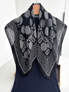 Close-up of black and white floral lace pattern on lightweight cotton linen scarf