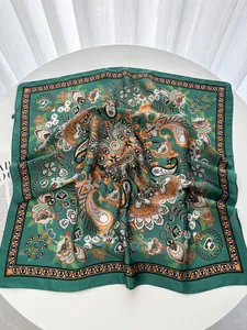 Detail of vintage green silk scarf with paisley floral pattern and delicate edge trim