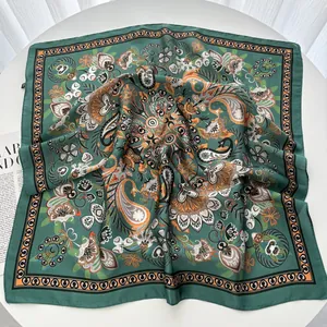 Detail of silk texture scarf with paisley floral pattern on a flat lay fashion magazine