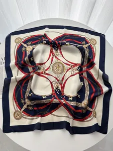 Détail d'un foulard en soie bleu marine et rouge avec boucles dorées et motifs de médaillons