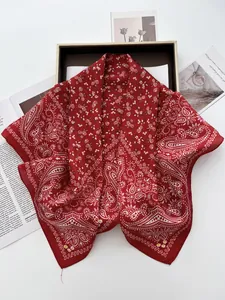 Close-up of red paisley silk scarf texture with fine floral patterns and smooth edges