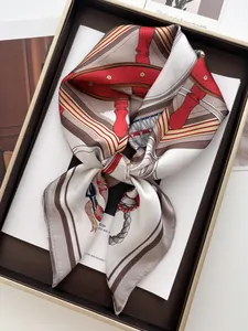 Macro view of nautical silk scarf with anchor rope prints in red and gold tones