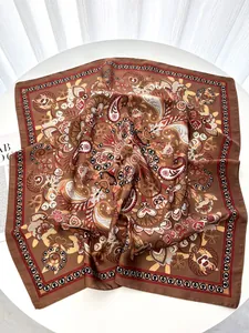 Detailed close-up of retro paisley pattern and floral print on bohemian silk scarf