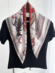 Detail of silk square scarf with nautical patterns of anchors and ropes on a black t-shirt