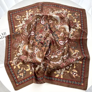 Detail of satin square scarf with vintage paisley pattern in brown and red silk finish
