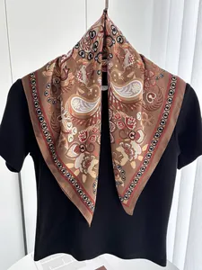 Detail of brown paisley silk scarf with vintage floral patterns and polka dot border
