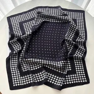 Detail of vintage paisley silk scarf with houndstooth pattern and geometric star prints
