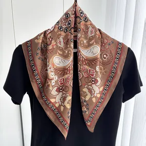 Close-up of vintage brown paisley silk scarf with decorative floral patterns and borders