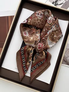 Detail of vintage paisley silk scarf neatly folded in an elegant brown gift box