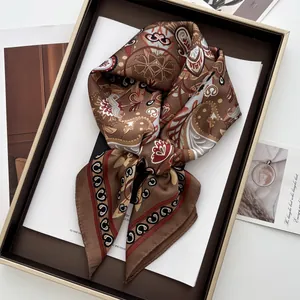 Close-up of vintage paisley pattern silk scarf elegantly tied in a gift display box