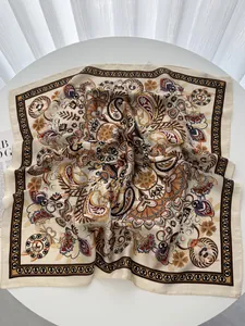 Detailed flat lay of bohemian silk scarf with retro paisley and floral patterns