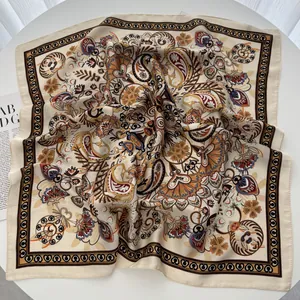Detailed view of bohemian paisley print silk scarf with intricate floral patterns on beige