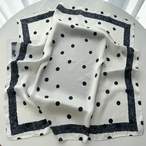 Detail of elegant black polka dot printed silk satin square scarf with border