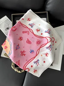 Detail of pink silk square scarf featuring American vintage patterns and glossy finish