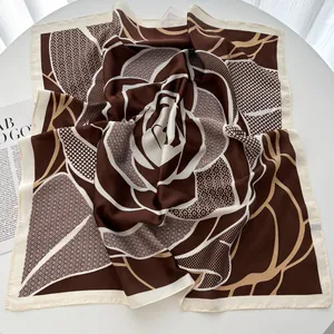 Detail of checkered floral silk scarf with hand-rolled edges and satin texture