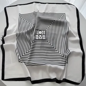 Minimalist black and white square silk scarf with geometric pattern and letter logo