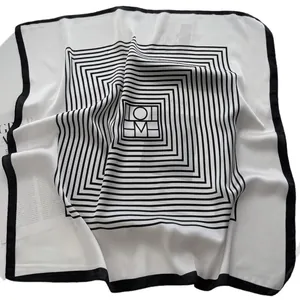 Elegant black and white square silk scarf with geometric patterns and HOM lettering