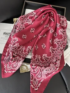Close-up of wine red paisley silk scarf with satin texture on a retro display background