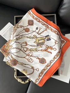 Detailed close-up of a luxury silk square scarf with vintage carriage and horsebit pattern