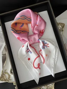 Detail of silk-texture floral scarf with retro rope and horseshoe prints in elegant pink