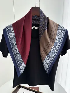 Detail of paisley silk scarf with burgundy and navy blocks worn on a black shirt
