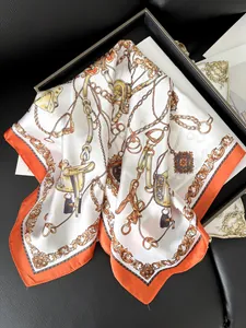 Detail of luxury silk scarf with orange borders and vintage equestrian horse motif