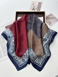 Detail of luxury paisley patchwork silk scarf with burgundy and navy blue pattern accents