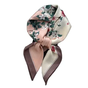 Carré de soie floral pour femme en rose et blanc noué en un élégant nœud papillon