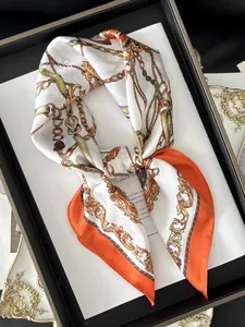 Detailed close-up of luxurious silk scarf featuring vintage gold chain and baroque patterns