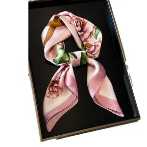 Elegant pink silk square scarf featuring realistic red rose floral prints in a gift box