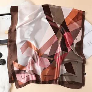 Fashionable silk scarf with geometric pattern in brown, pink, and orange tones