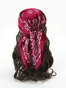 Detail of burgundy satin square scarf featuring a classic white paisley pattern