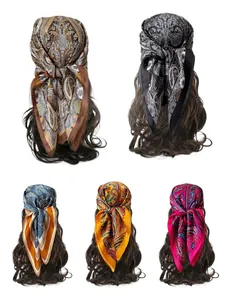 Detail of five paisley pattern silk scarves styled as hair bands on long wavy hair