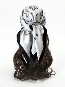 Detail of white paisley silk scarf with black border tied on a model with long hair