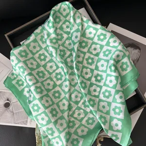 70cm green and white checkered silk scarf with floral patterns displayed on a tray