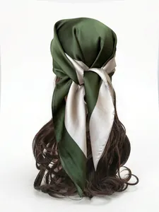 Detail of silk satin scarf in forest green and champagne gold tied as a hair accessory