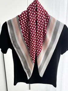 Detailed view of polka dot silk-feel square scarf with multi-color striped borders