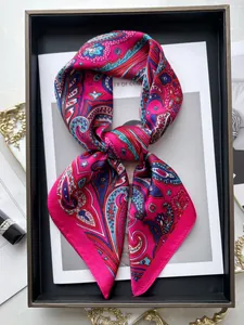 Detail of French vintage paisley silk scarf in fuchsia with elegant tied knot styling