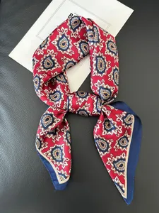 Close-up of silk-textured paisley scarf with red white and blue patterns on leather