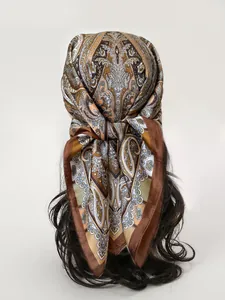 Detail of vintage paisley silk scarf tied as a headband on mannequin with curly hair