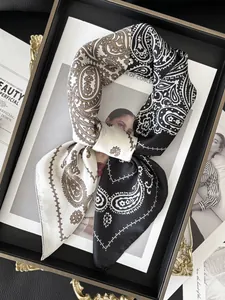 Detail of a vintage paisley silk scarf with contrast patchwork in black and brown