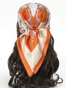 Baroque pattern orange and white silk square scarf tied as a stylish headband on hair