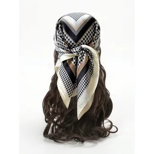 Silky geometric print square scarf worn as a stylish headband on long wavy hair