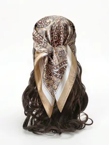 Detail of vintage paisley silk scarf styled as a headband on long brown wavy hair