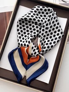 Detail of silk-like polka dot scarf with colorful block stripes and rolled edges