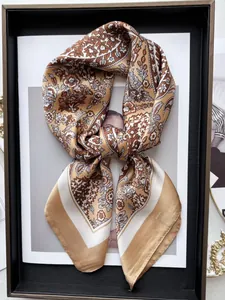 Detail of vintage floral silk scarf with gold paisley patterns in a luxury display