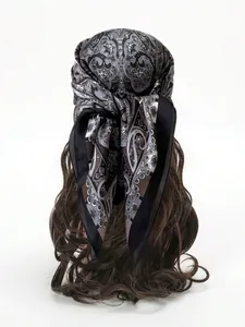 Detail of paisley silk scarf on wavy hair showing vintage pattern and smooth texture